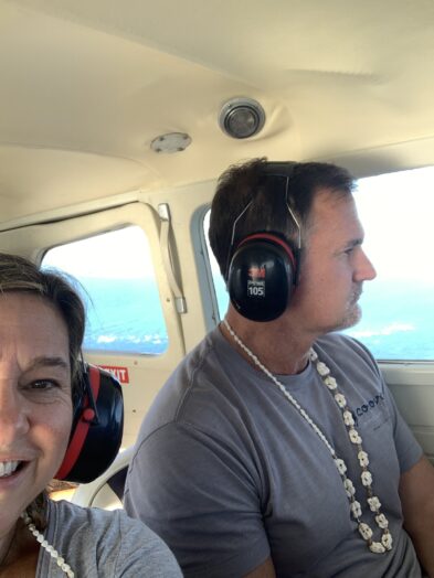 Two people riding on a seaplane with headphones