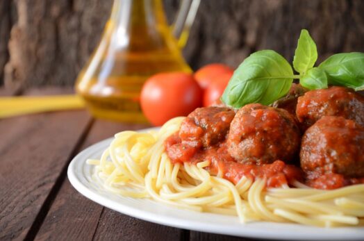 a plate of spaghetti and meatballs i an italian restaurant