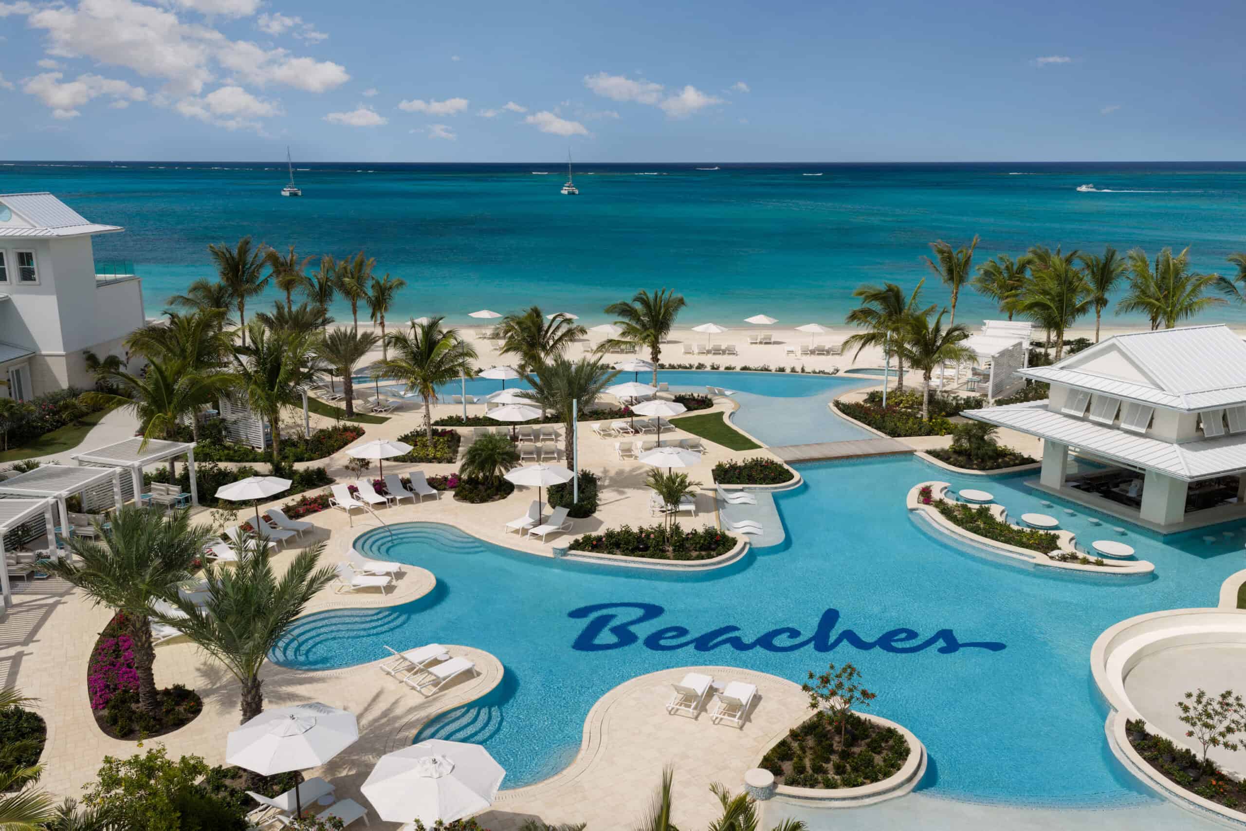 Beach resort pool with ocean view in the Caribbean, perfect for family vacations.