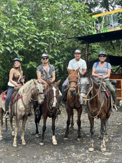 a family riding horses in la fortuna