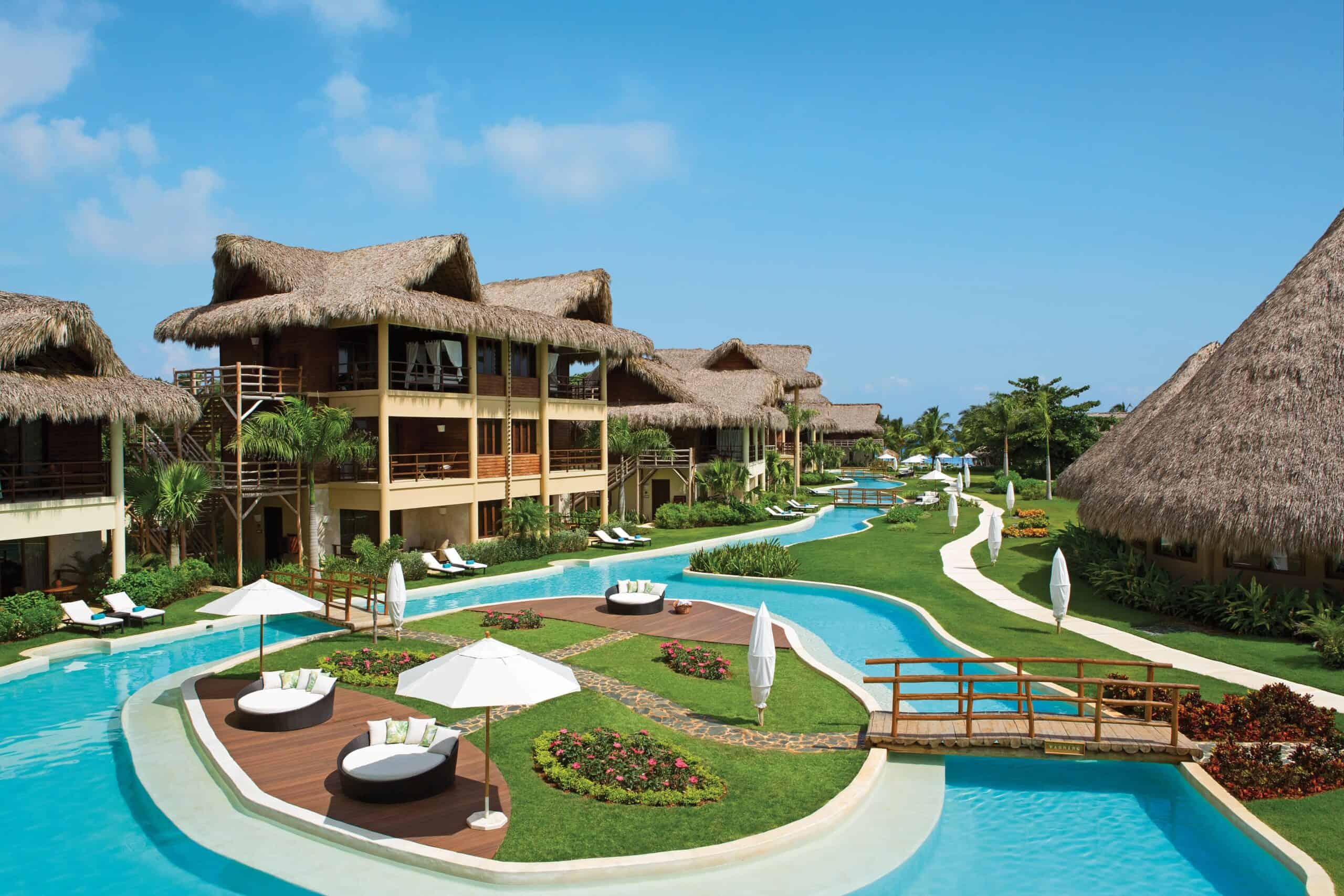 Overwater bungalows and tropical pools at a Caribbean resort for couples.
