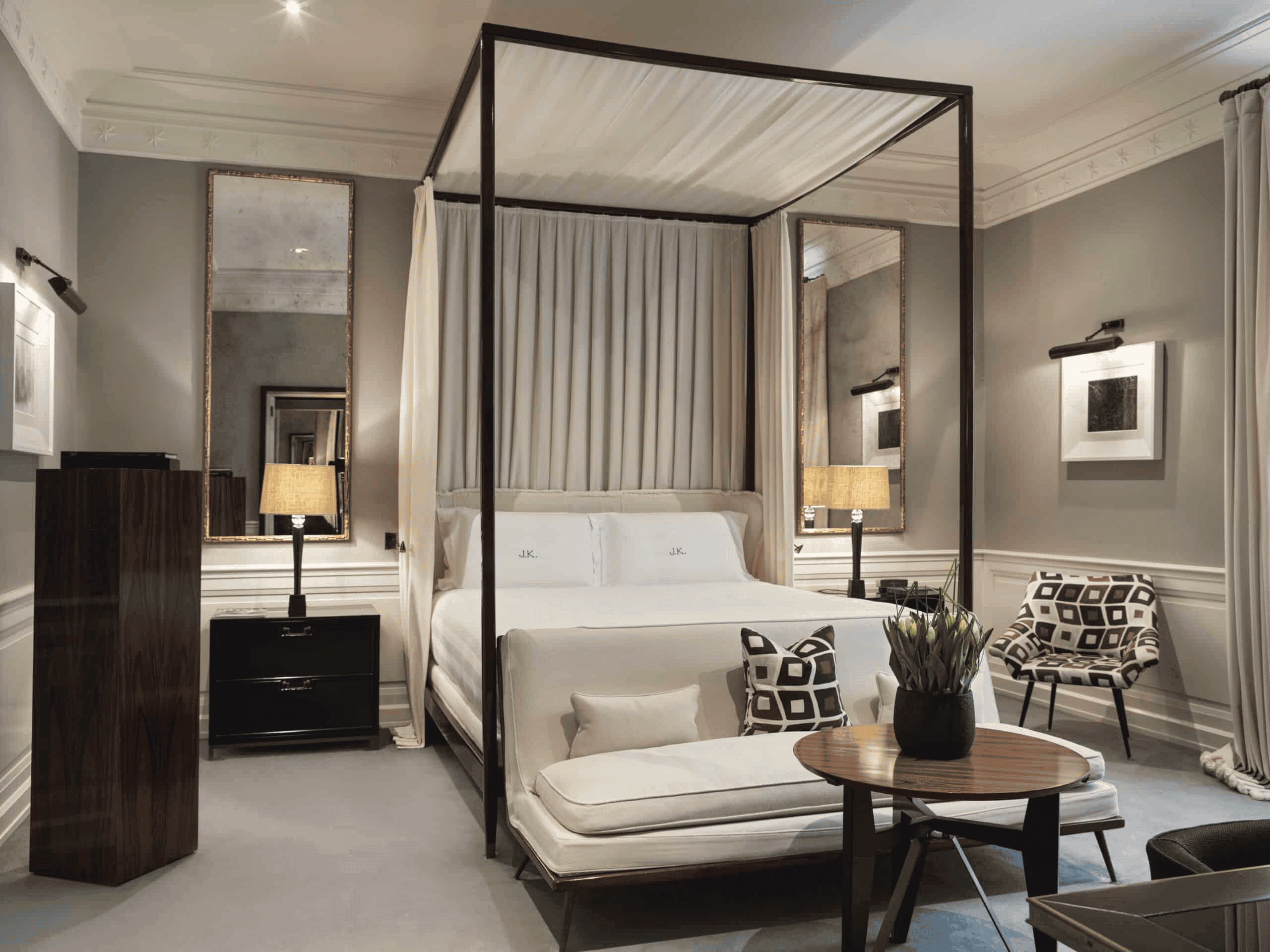 Luxury hotel bedroom with a stylish canopy bed, contemporary furniture, and elegant decor for a rela.