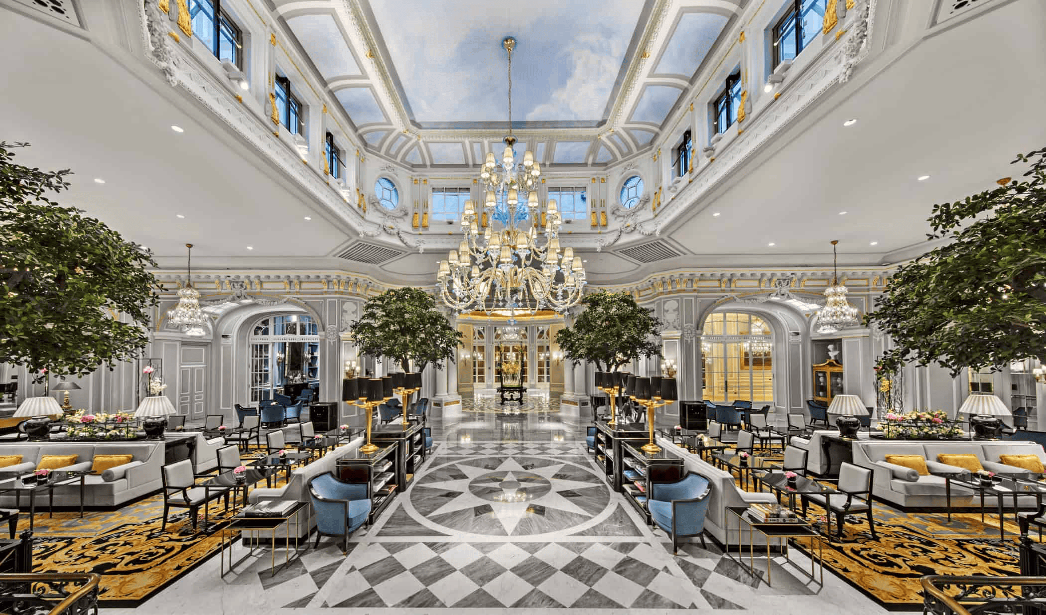 Elegant hotel lobby with grand chandelier, ornate ceiling, and stylish seating areas for a luxurious.