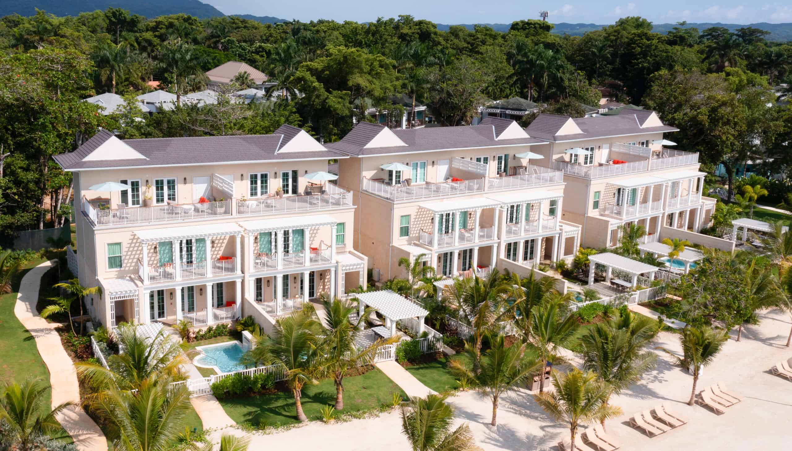 Beachfront Caribbean family resort with modern villas and lush tropical landscaping.
