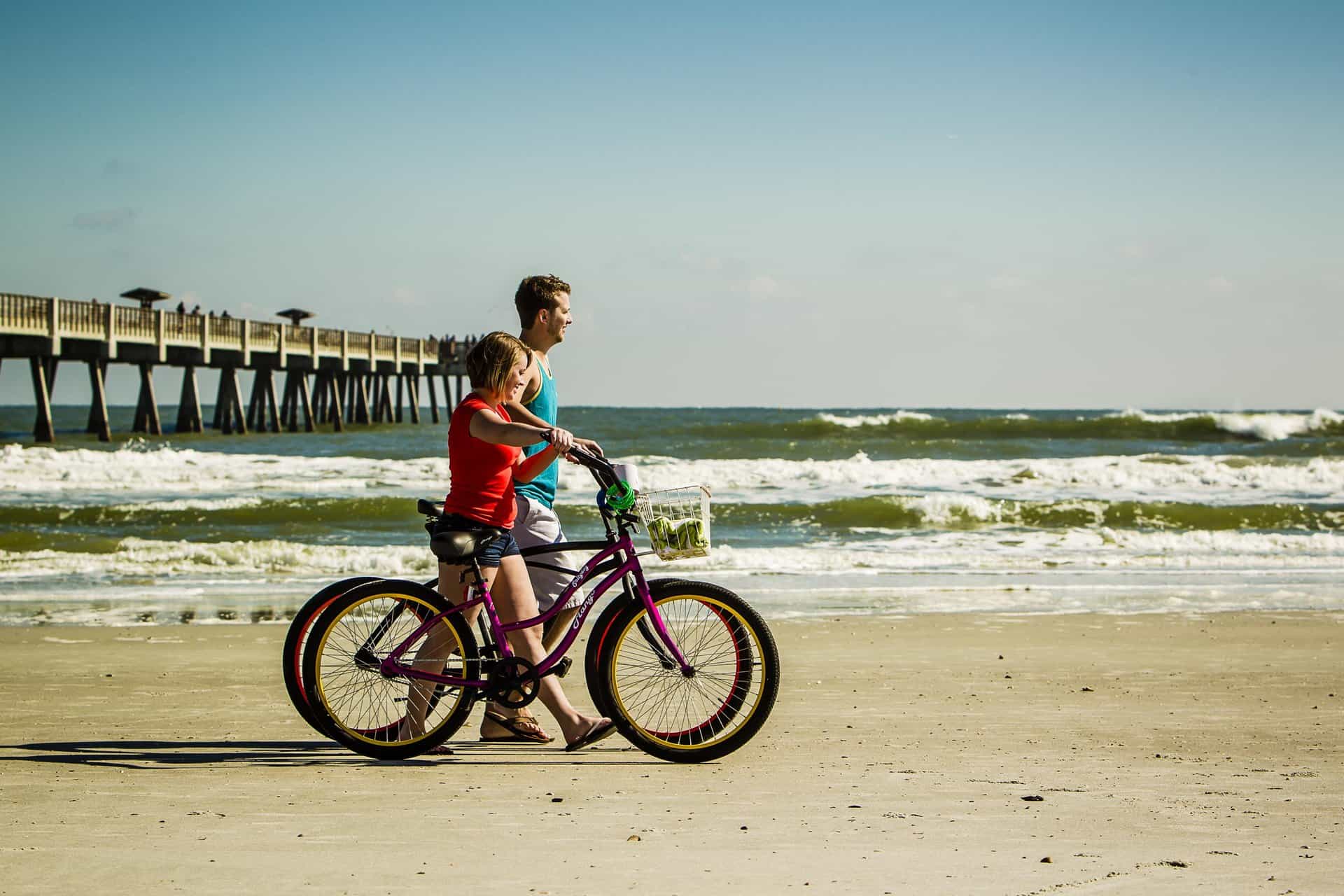Family enjoying cycling along the beach at Amelia Island, a top destination for scenic coastal adven.