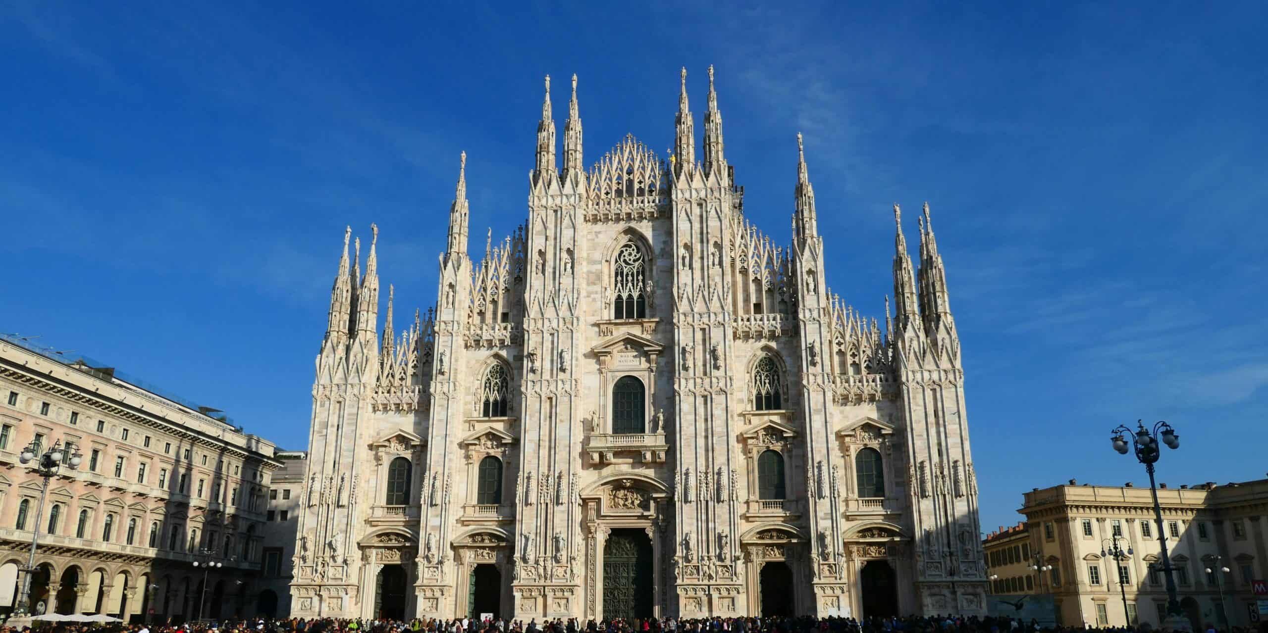 Milan Cathedral, a stunning Gothic masterpiece, dominates the city skyline with intricate details an.