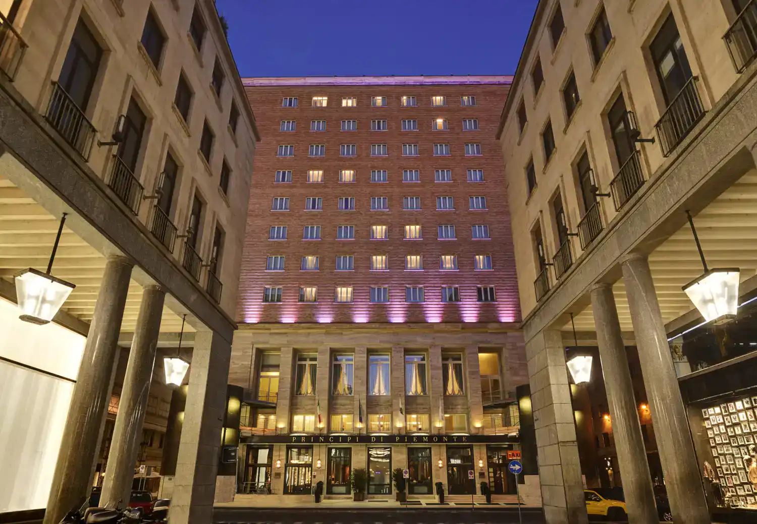 Night view of Beth Well Traveled hotel with illuminated facade and grand entrance in downtown.