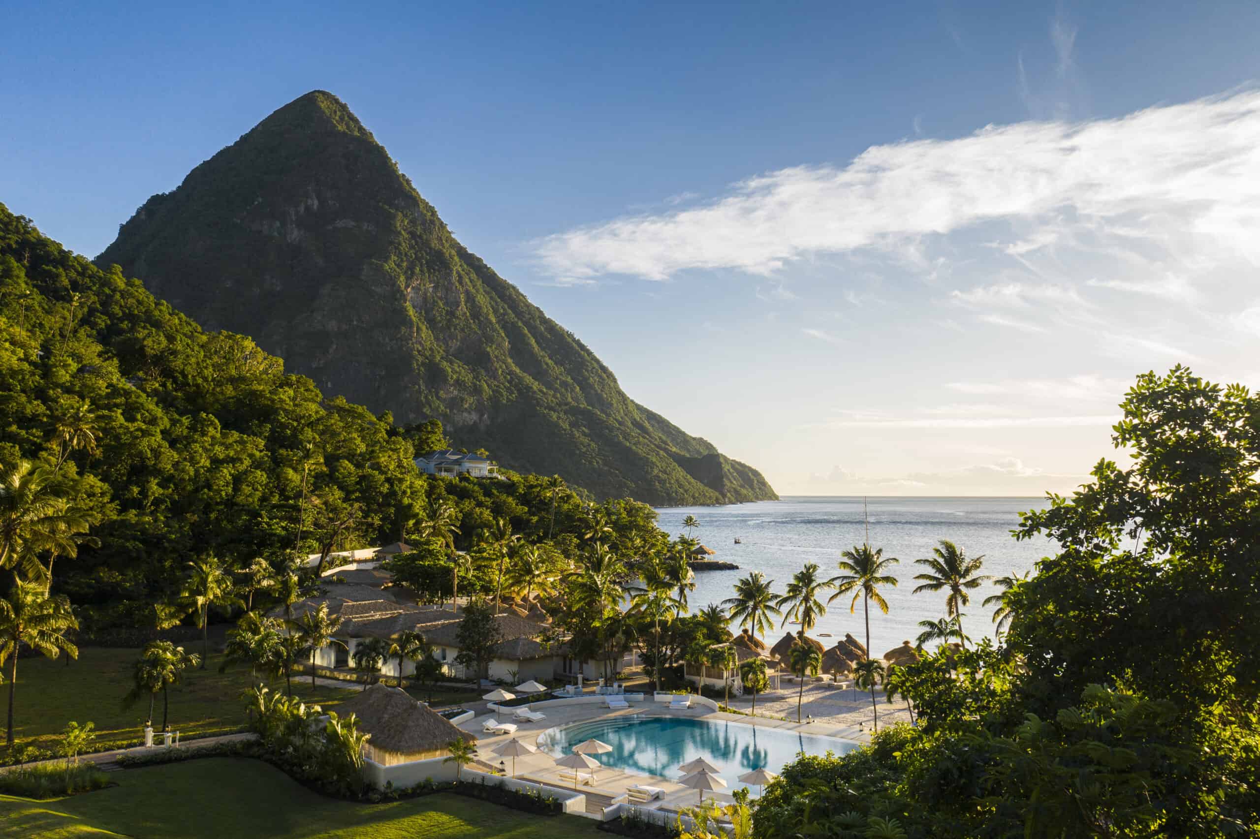 Tropical island resort with mountain, palm trees, and ocean view, perfect for travel and vacation ph.