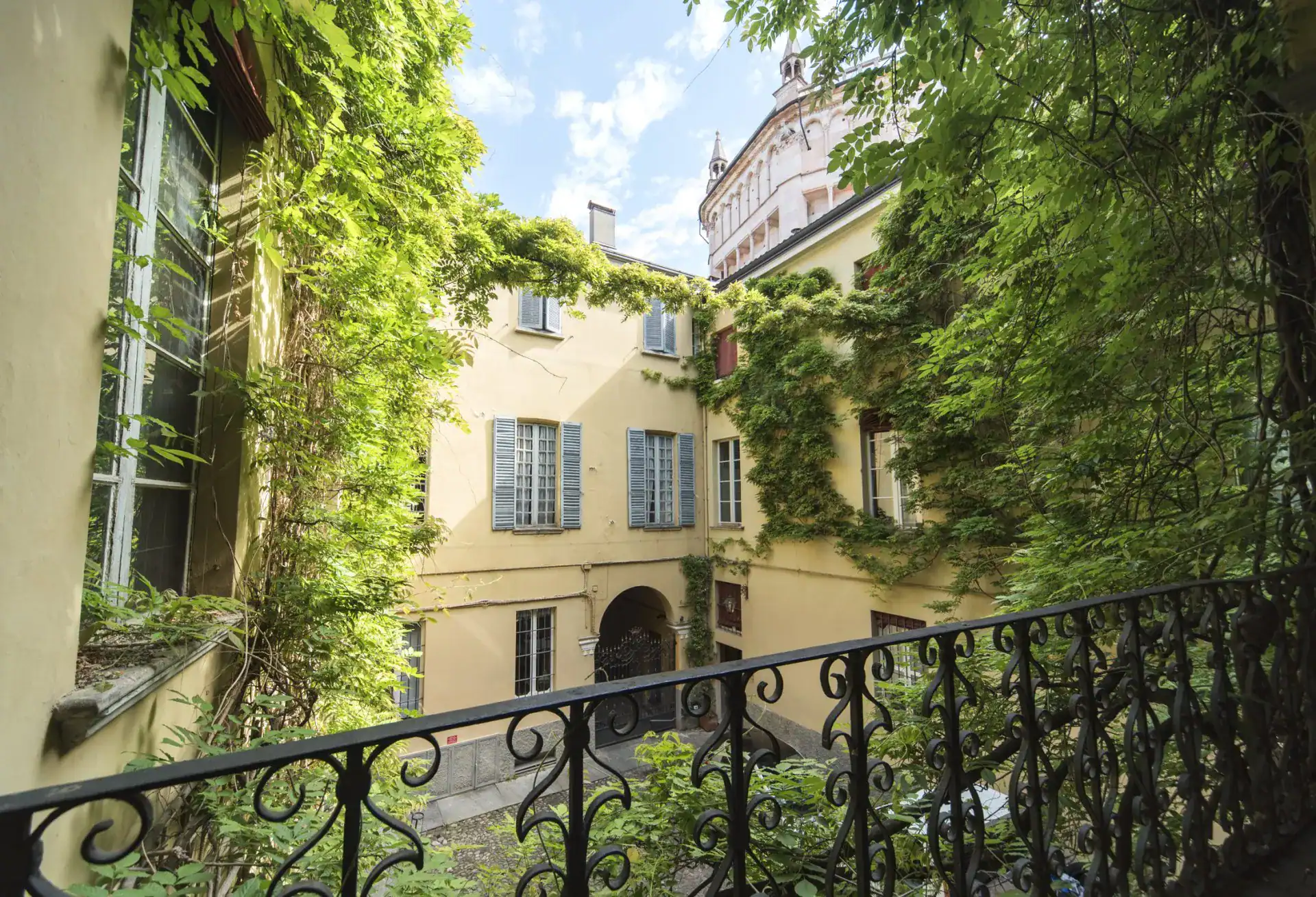 Beautiful European courtyard with lush greenery and historic architecture, perfect for travel photog.