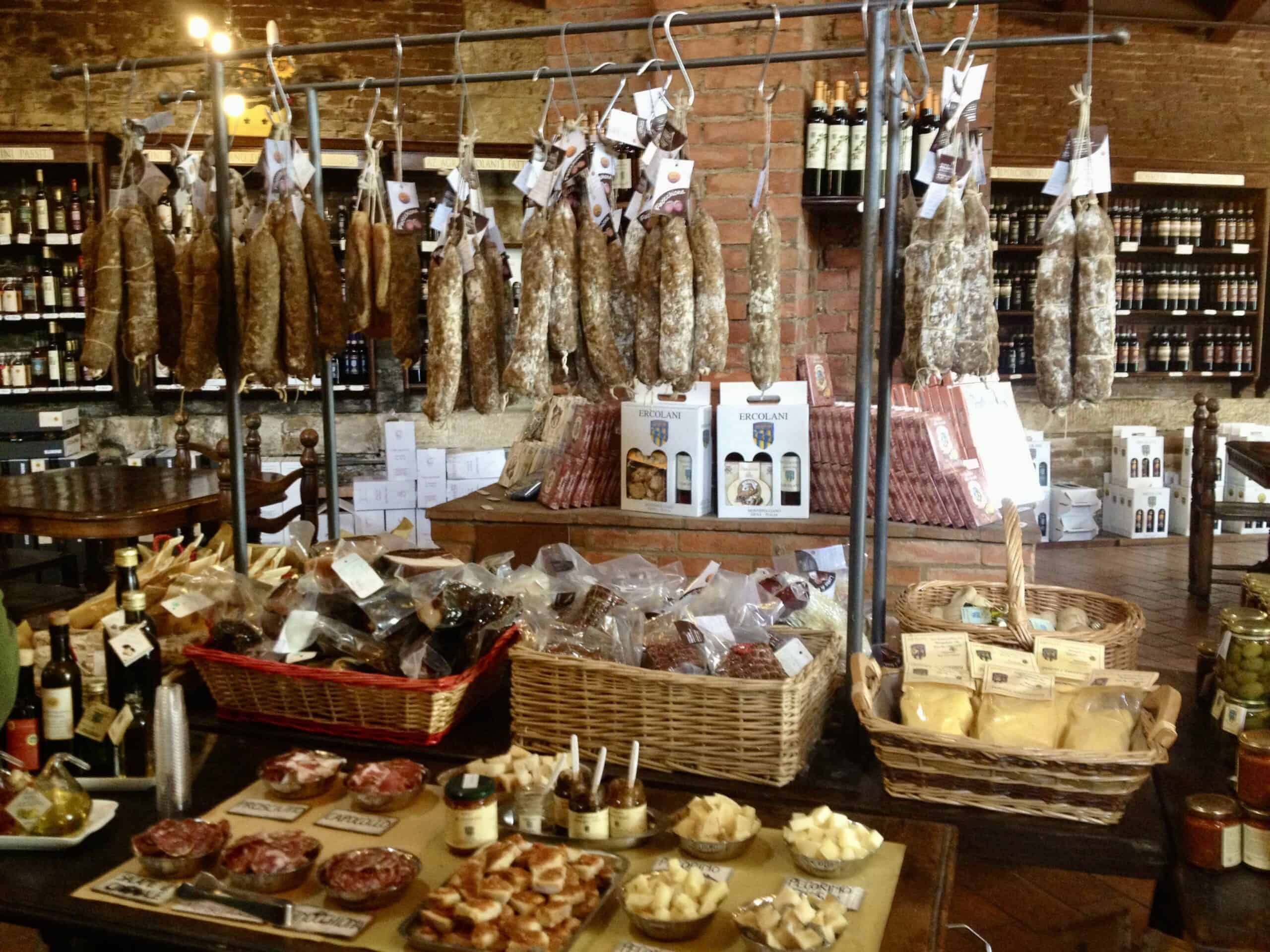 Premium smoked meats and artisanal cheeses displayed in a rustic shop setting.