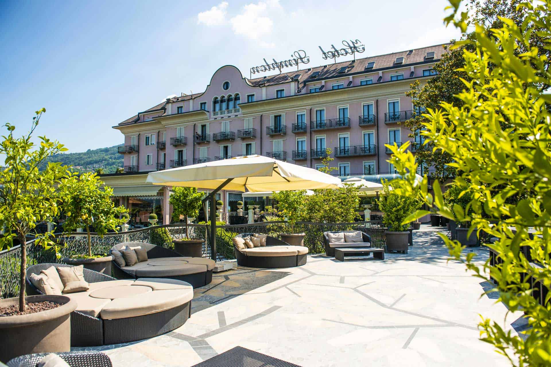 Luxurious hotel terrace at Lake Maggiore featuring outdoor seating and scenic views.