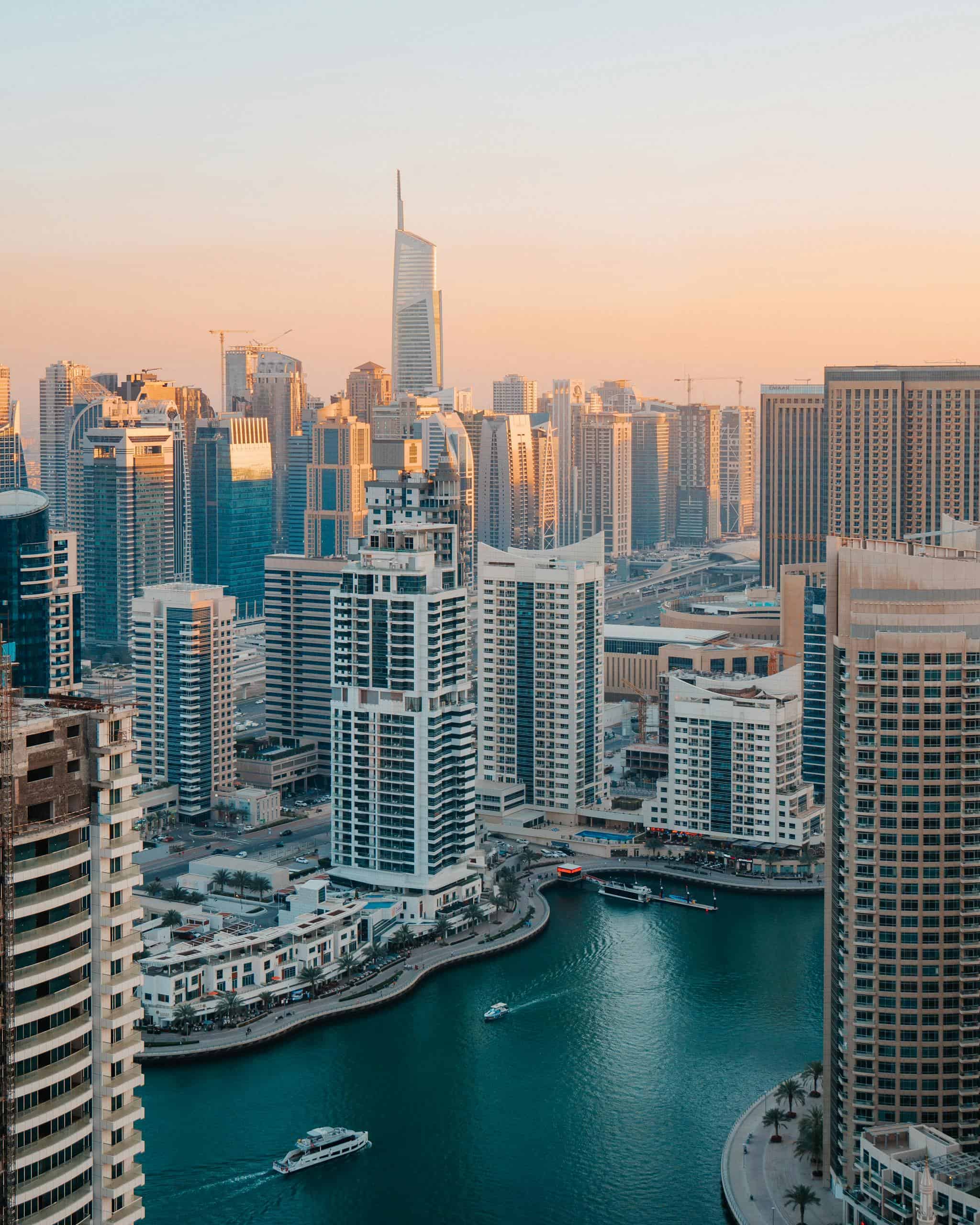 Dubai cityscape with tall buildings and a waterway, showcasing urban architecture and luxury lifesty.