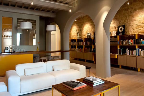 Bright, inviting living room featuring a white sofa, wooden coffee table, and a large bookshelf with.