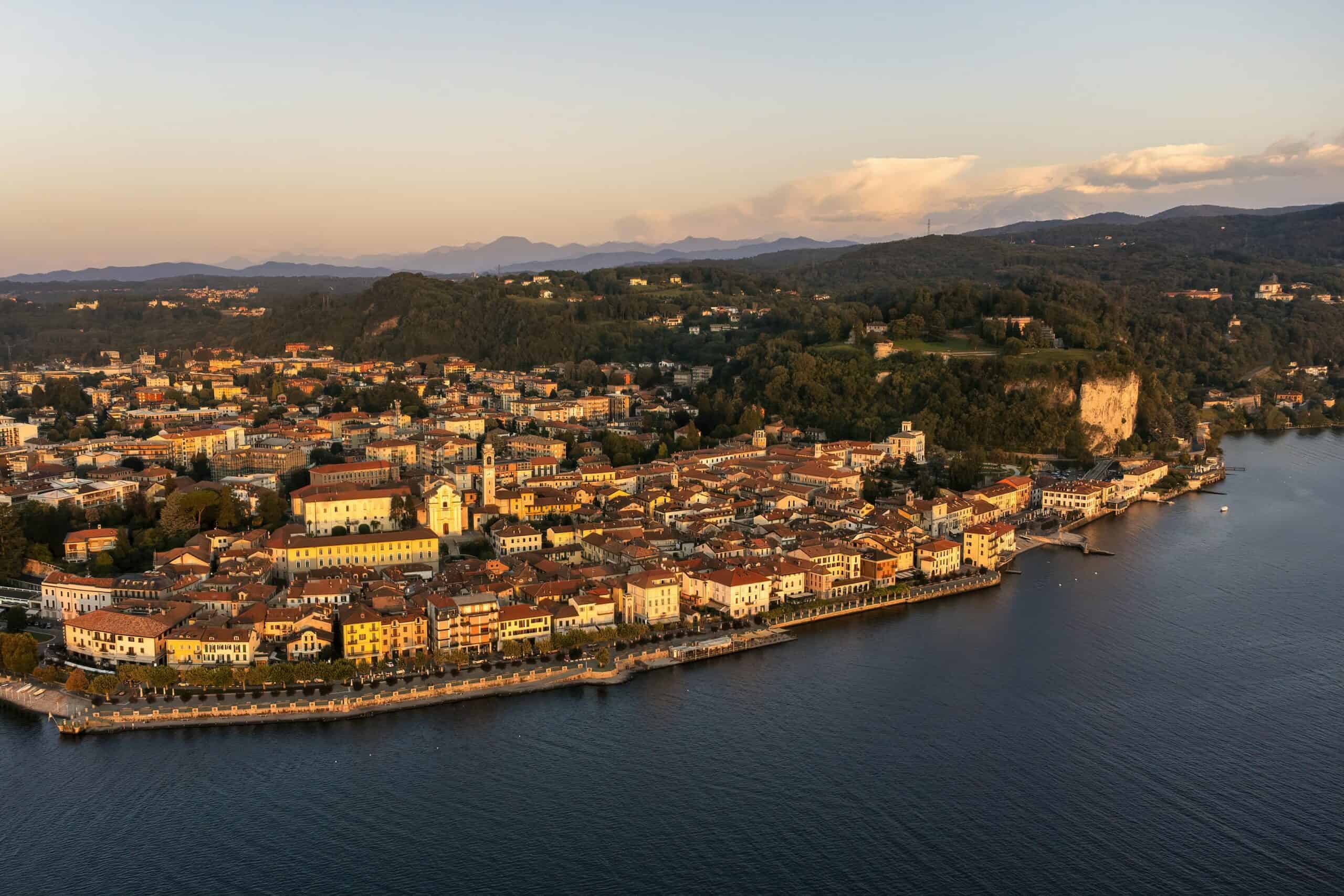 Historic Italian coastal town with colorful buildings along the waterfront at sunset.