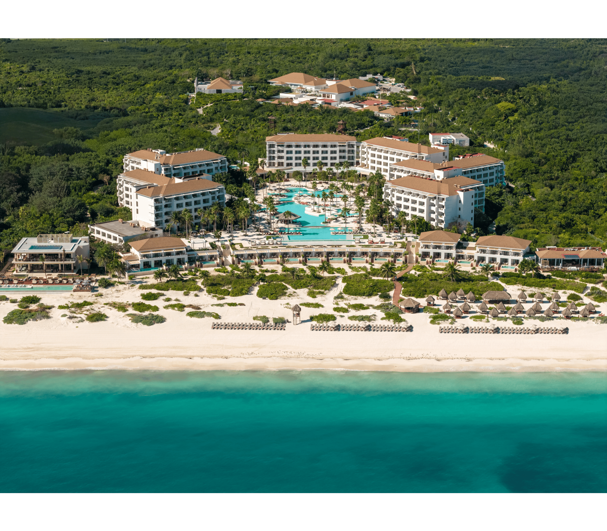 Beachfront Cancun resort with pools, lush gardens, and ocean views.
