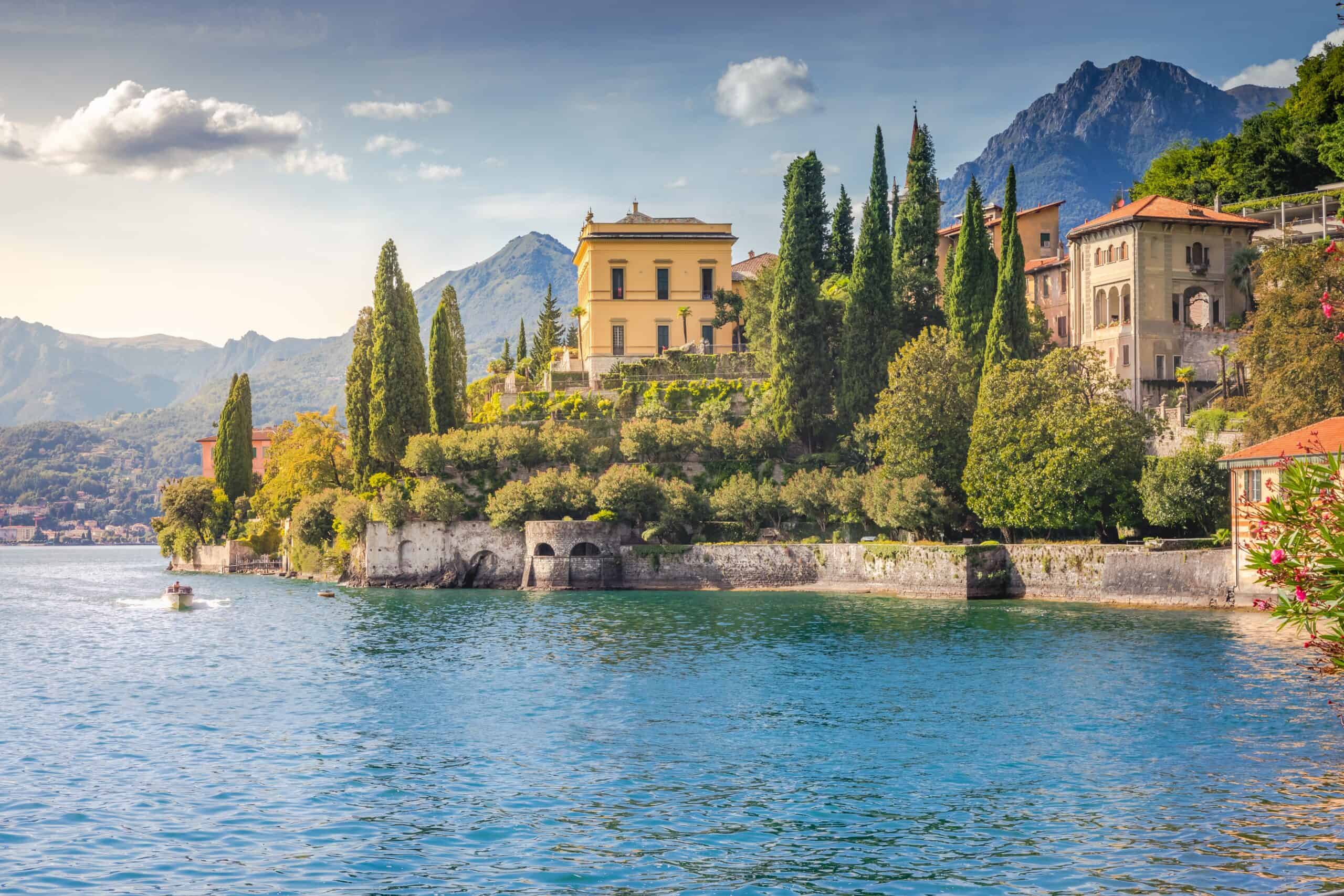 Scenic view of Lake Como featuring colorful villas, lush greenery, and mountain backdrop, ideal for.