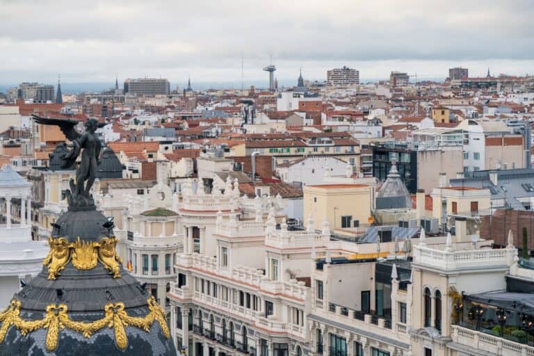 Panoramic view of Madrid with historic buildings and cloudy sky.